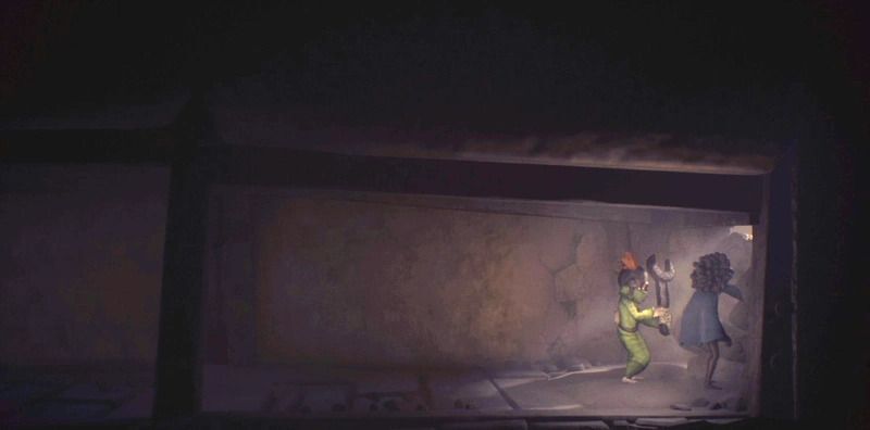 通路の中の石壁をスパナで壊す